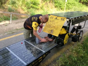Cleaning the solar panels after muddy section of the day