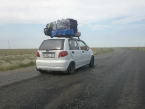 Such a small car can devour four burly Uzbeks and carry them several thousand miles home
