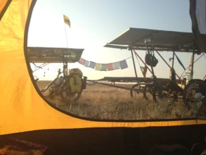 Camping with Buddhist prayer flags. Hopefully they will bring good luck and we will reach our destination.