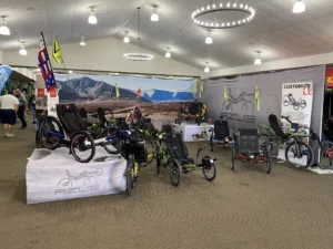 AZUB had one of the largest booths this year and in addition to their iconic off-road trike, the Ti-FLY X, they also brought a new addition in the form of the AZUB T-Trisek for kids and short adults.