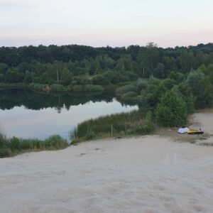 Tent and a velomobile at a lake