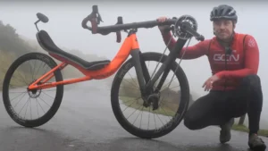 GCN riding a Cruzbike recumbent over a mountain pass in Wales