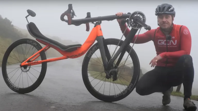 GCN riding a Cruzbike recumbent over a mountain pass in Wales